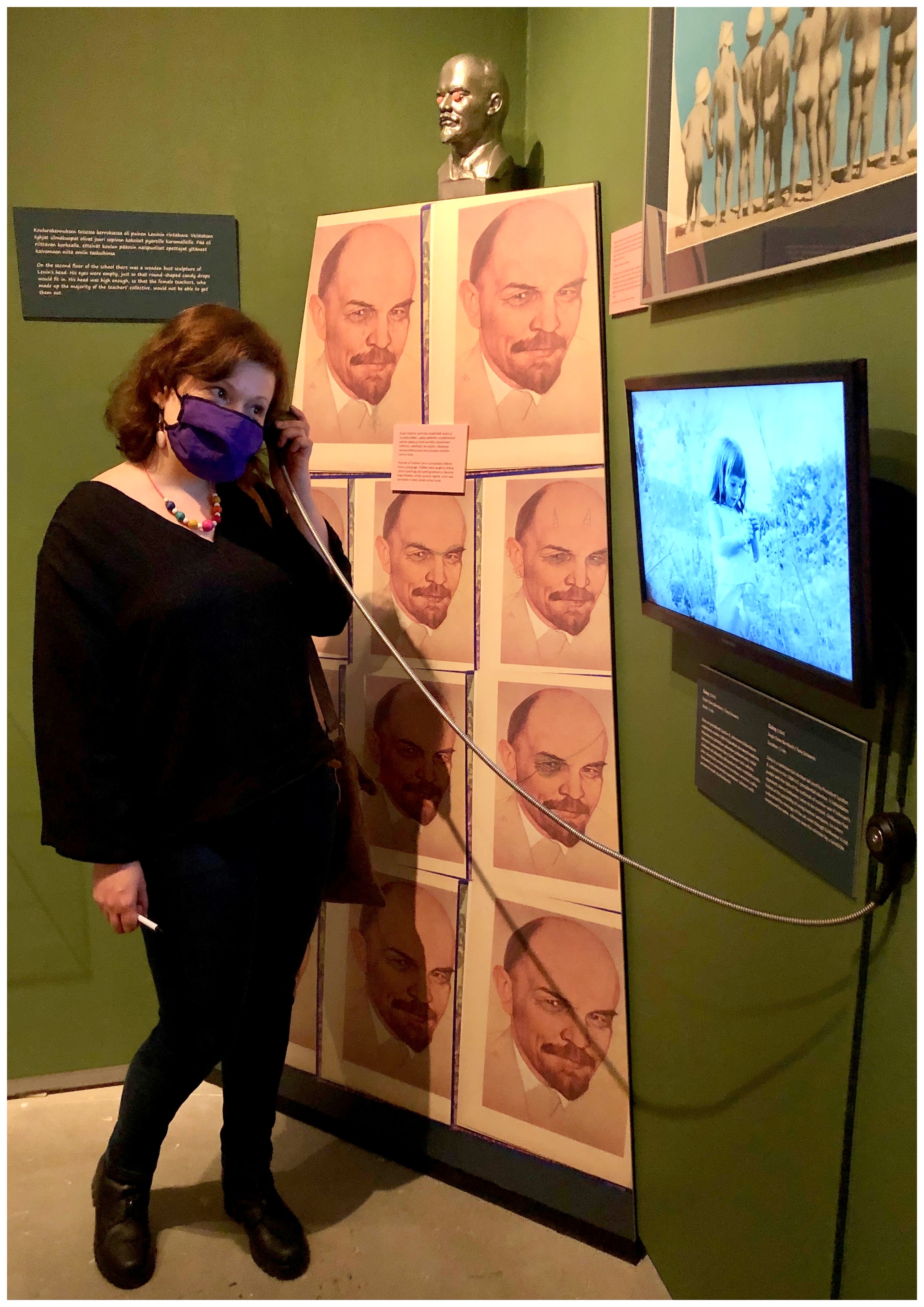 A person trying out an old telephone in the exhibition.
