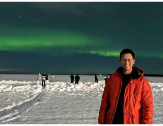 A photo of SA Anton Reloj with the northern lights behind him