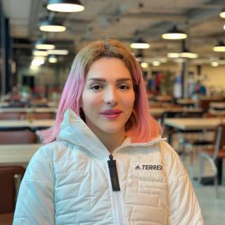 Student Ambassador Elnaz sitting at a table.