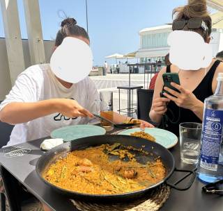 Sharing a paella with friends by the Malvarrosa beach