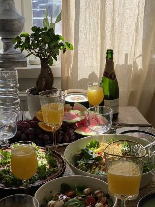 A table that is filled with food, drinks, and plants