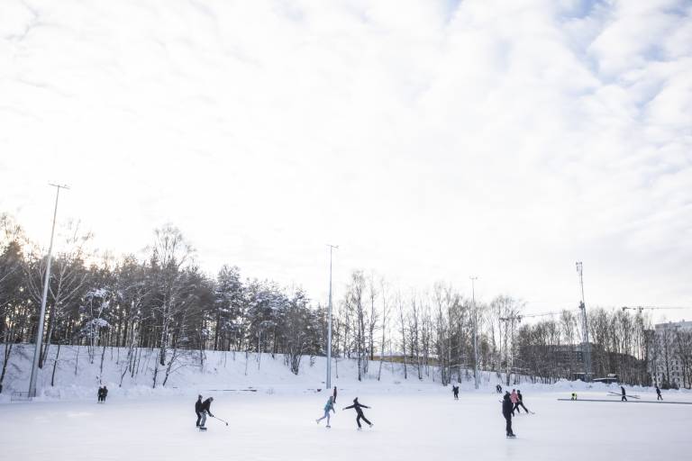 Photo of people skating on a snowy day in Tampere