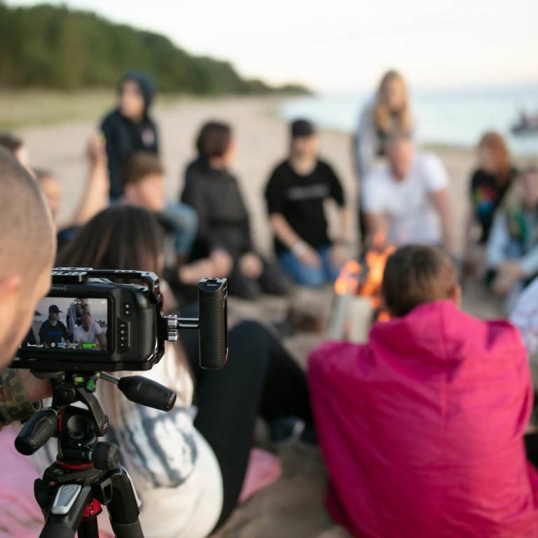 young people at camp fire