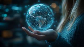 A hand holding the globe.