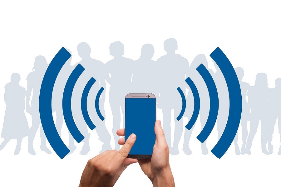 Two hands holding a gadget that is sending signals.