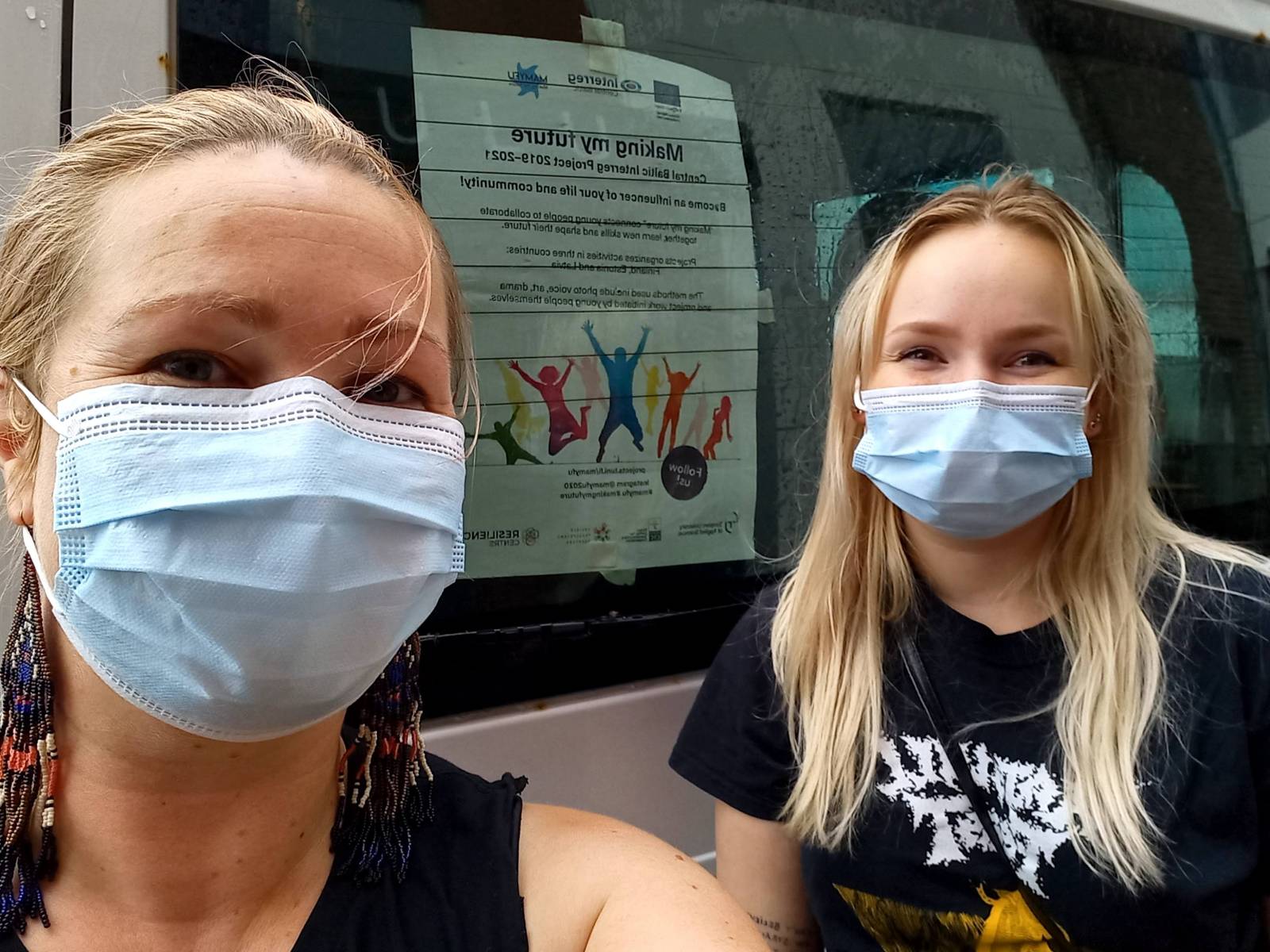 two women in front of a car