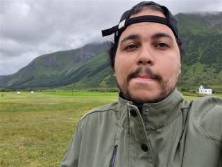 Amine, in the countryside. He has a reverse hat on.