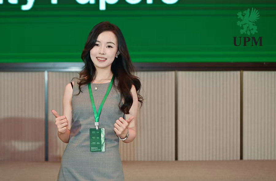 A young woman holding thumbs up.