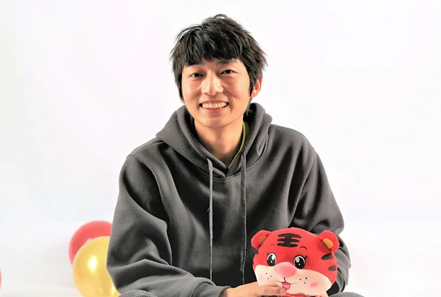 A young man smiling.