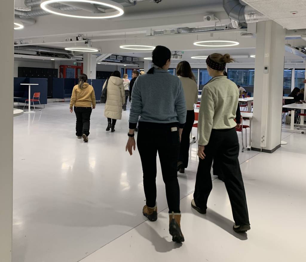 People walking indoors in a walking meeting