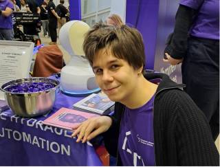 A person smiling and a robot