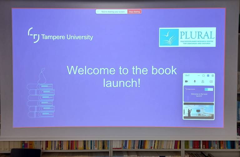 Image showing a screen with a PowerPoint slide saying Welcome to the book launch