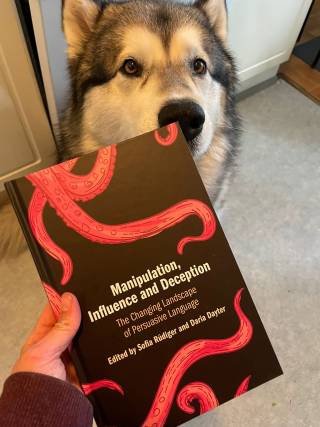 Image shows a book cover and a dog