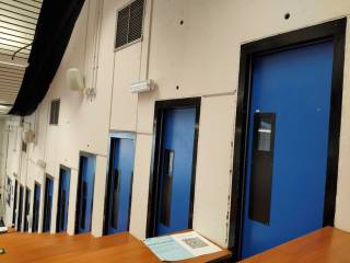 The image shows a corridor with doors