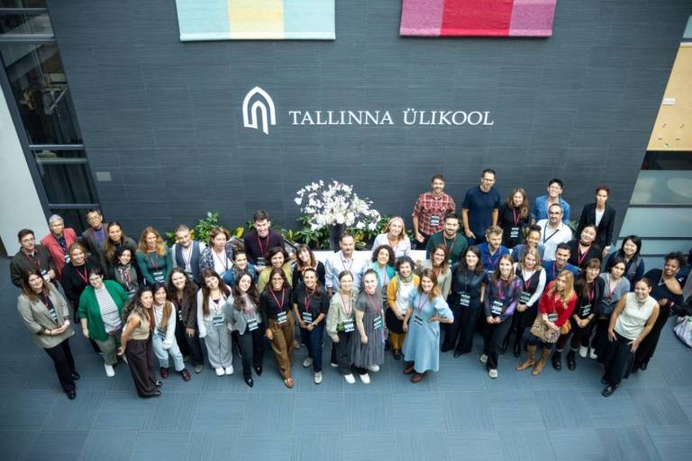 The image a group photo of conference participants