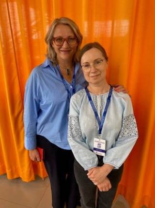 The image shows Dr Olga Nenonen standing next to a colleague