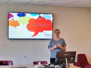 The image shows Prof Kaisa Koskinen presenting a talk on "Paraprofessional translators: What is it and why study it?"