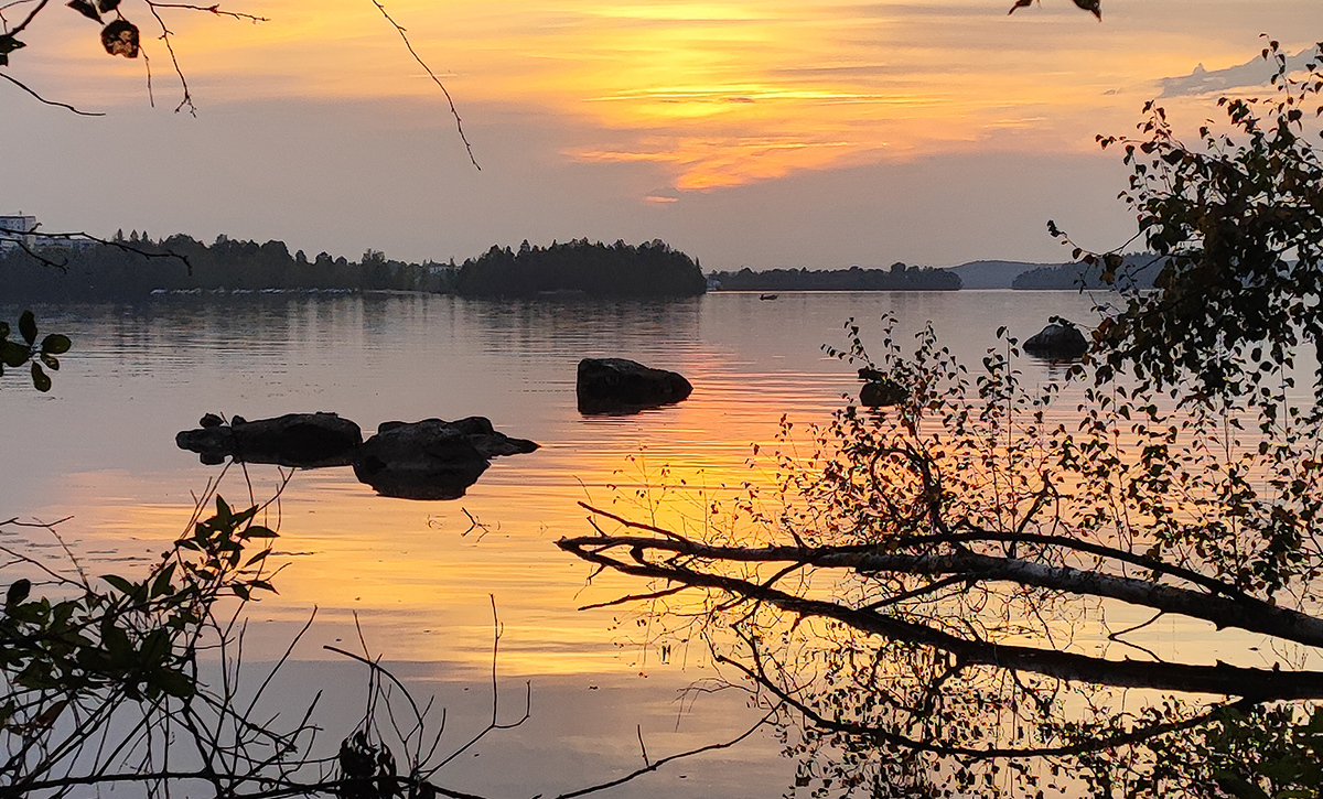 Calm Finnish lake at sunset reflecting silence and natural beauty