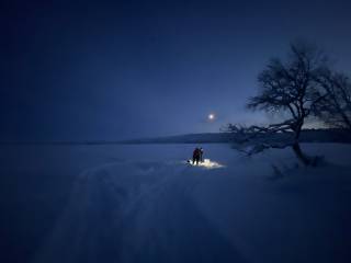People getting water from a lake in Lapland.
