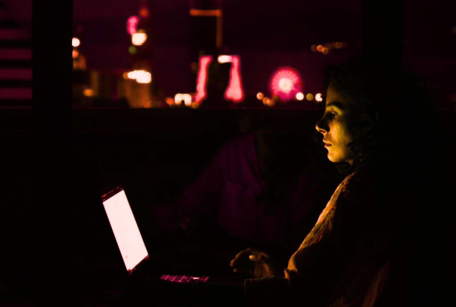 Woman on laptop with orange nightly flow.