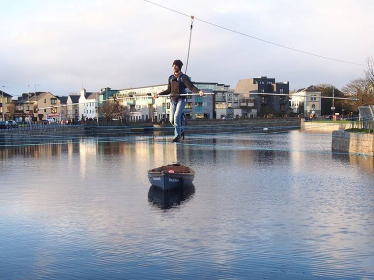 lternative text: A tightrope walker crossing the River Corrib in Galway.
