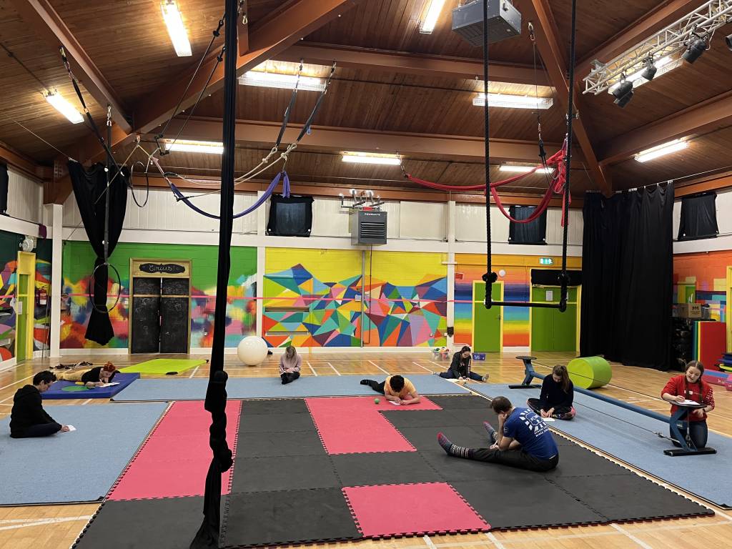 Participants in a circus space, exploring the impact of a social circus training programme.