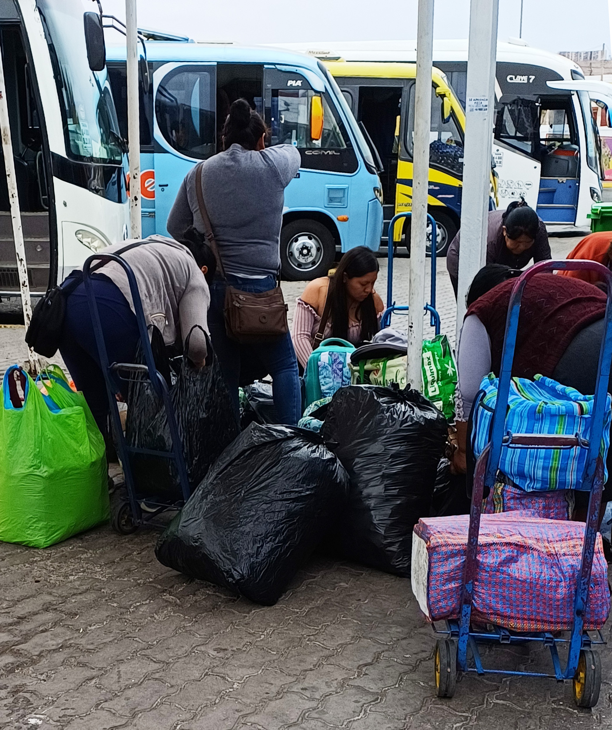 Women with carry-on luggage at the international terminal, Arica bus station