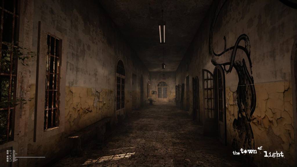 dilapidated dark hallway with cracked paint and graffiti