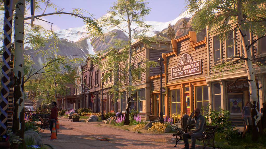 Street with old wooden buildings. People roaming around the street. There is a snowy mountain on the background.