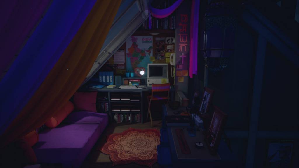 Sleeping/living loft full of warm, deep colours. Religious symbols, map of India and photos clutter the wall. Sleeping mattress on the floor, curtains overhead it as "roof".