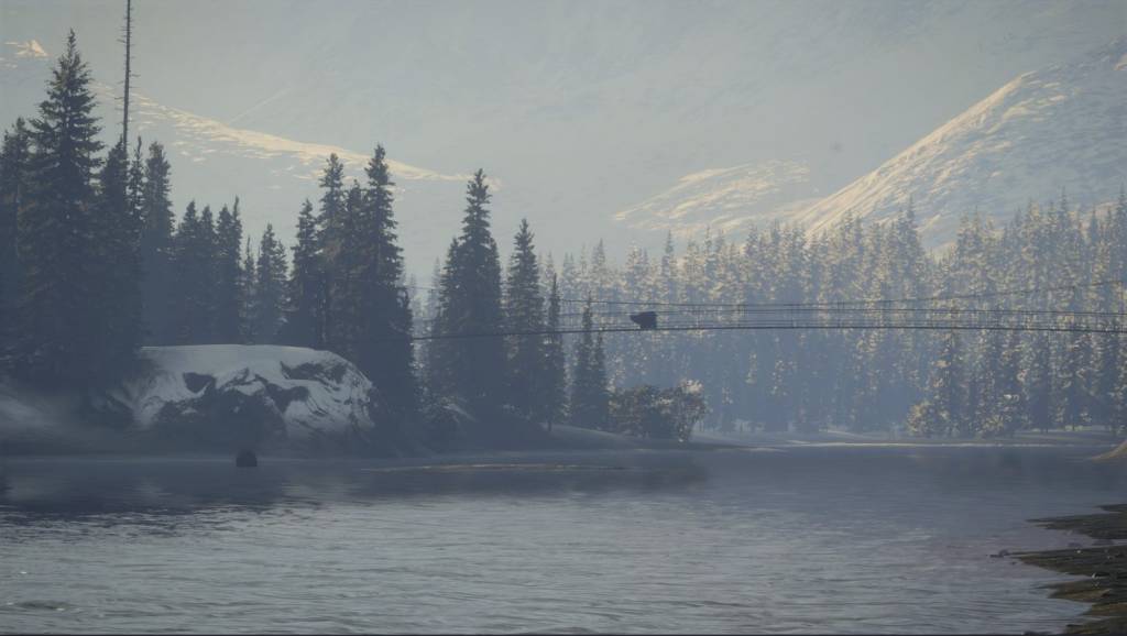 Two bears next to a forest, one is drinking from a river and another is on a bridge above the river. Mountains in the background.