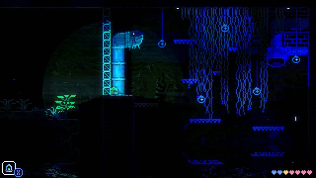 The player character of Animal Well, a small blob, shines a light through a glass wall into a shrubby area.