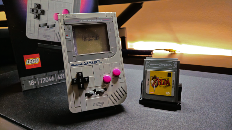 next to instructions|LEGO Game Boy set being built on a desk