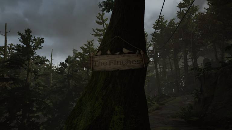 adorned by ornamental birds has been se to hang from the side of a tree. It reads: "Finches".
