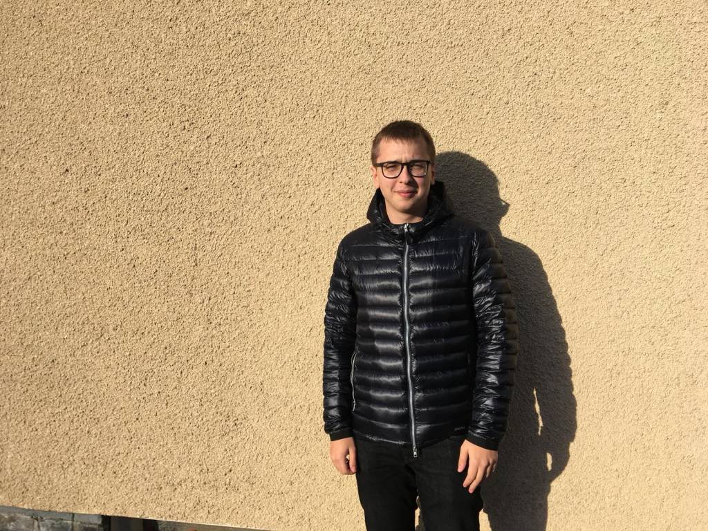 Student Ambassador Nikolai Sladkov standing next to a wall