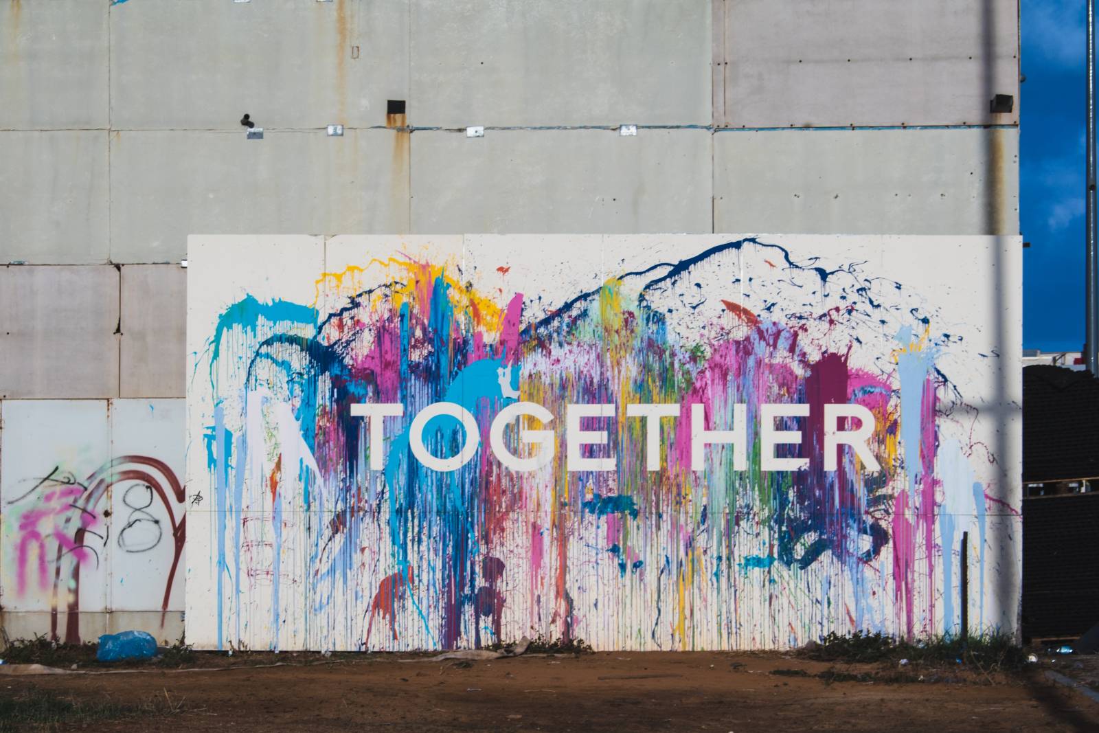 Värikäs graffittiseinä, jossa lukee Together.