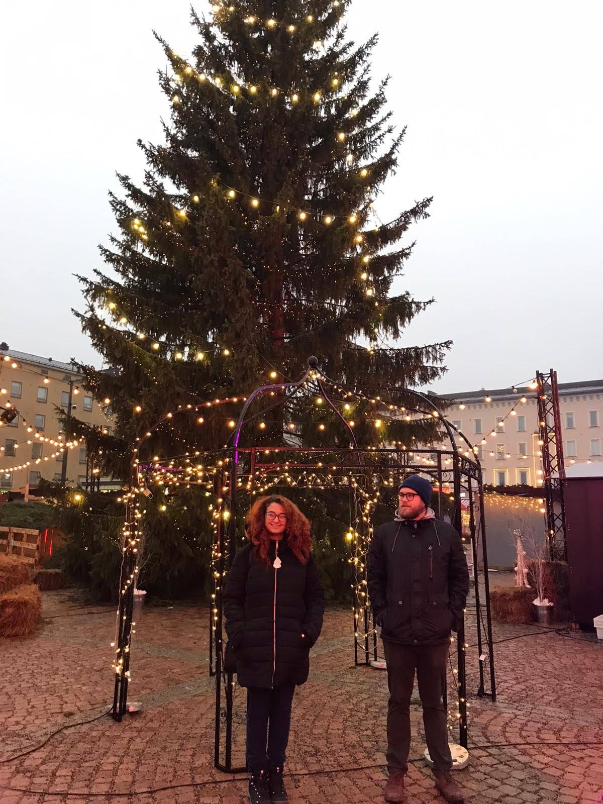 Raysa in front of a Christmas tree.