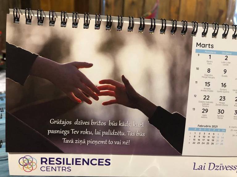 picture of two hands on a calendar page