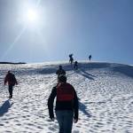 People hiking on a snowy mountain