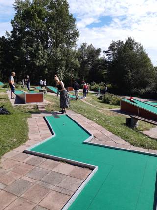 person playing minigolf on a sunny day