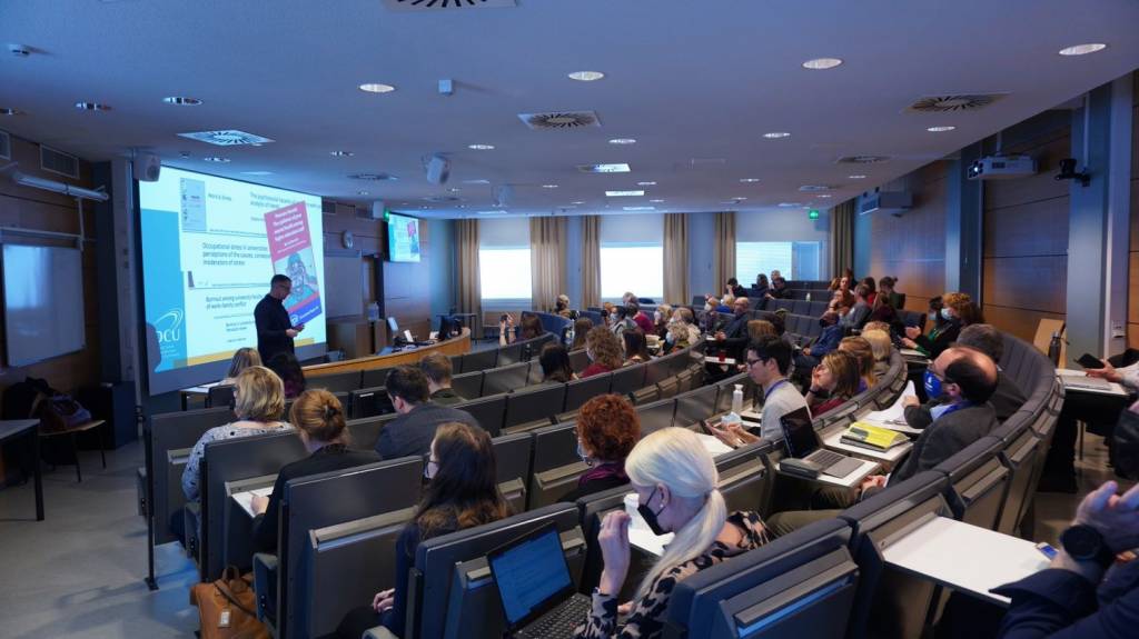 A classroom full of people listening James Brunton.