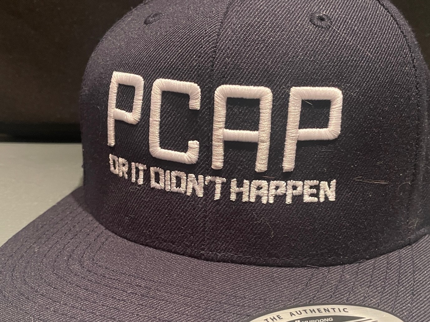 A cap with a text: "PCAP" or it didn't happen.