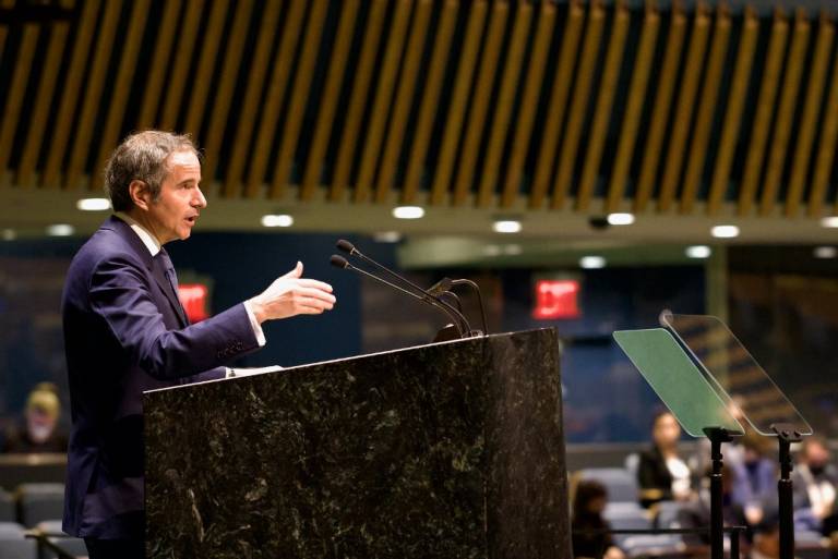 IAEA Director General Rafael Mariano Grossi standing in front of an audience in a podium and giving a speech at the United Nations.