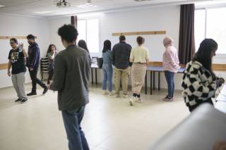 Students at Al-Quds University in an exhibition made by community work.