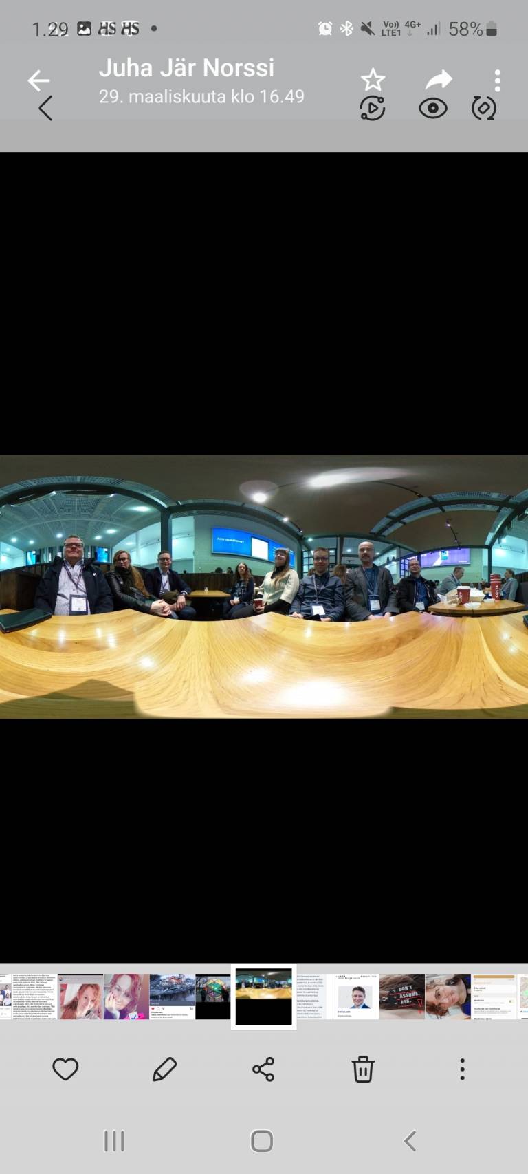 Kuva, joka otettu 360 kameralla, ja jossa ihmiset istuvat pöydän ääressä