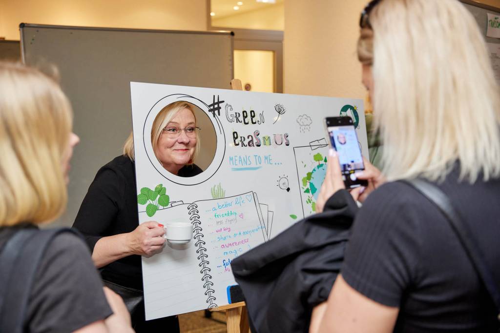 Sanna Ruhalahti posing with a poster.