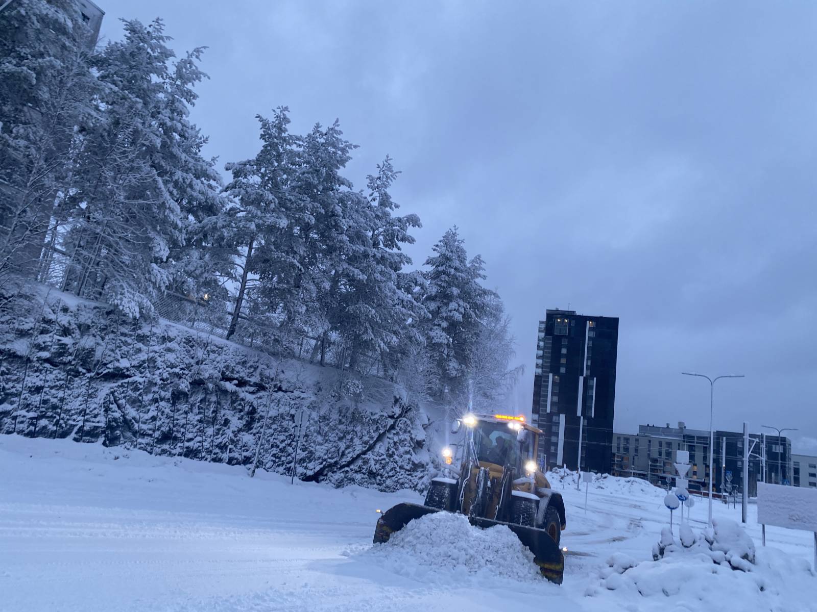 A snowy winter in Tampere with a tractor clearing the snow for more car accessibility