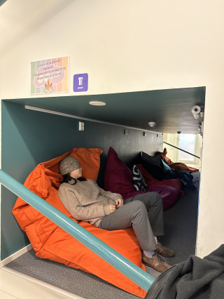 Author Du taking a nap in a beanbag in the sleeping tunnel.