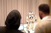 Two students interacting with NAO.
