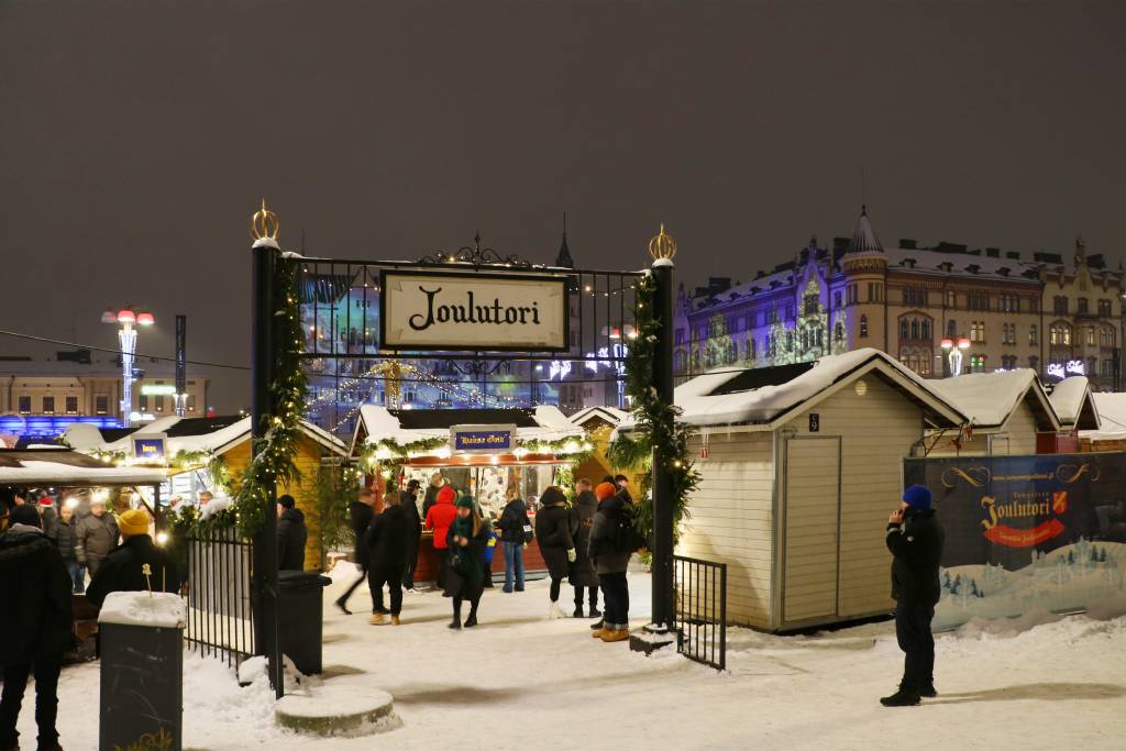 Christmas market in a evening light. Text: Joulutori.